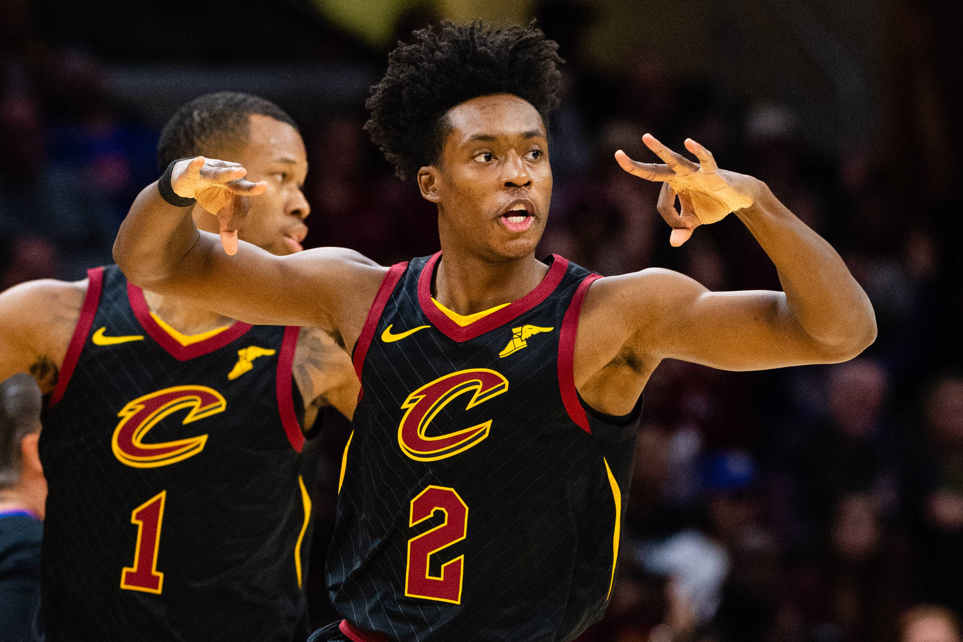 Collin Sexton Making A Three-point Sign In A Basketball League. Background