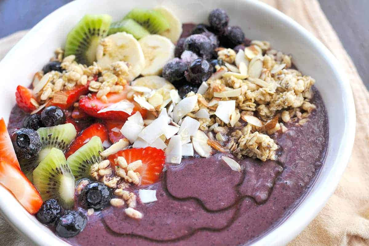 Colorful Acai Bowl With Fresh Fruit And Granola Background
