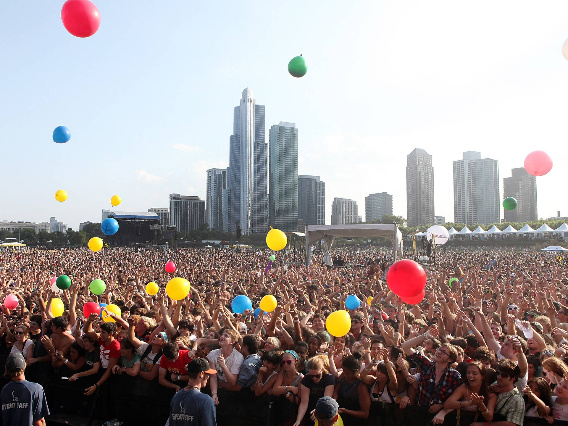 Colorful Balloons In The Sky Against The Vibrant Chicago Skyline At Lollapalooza Background
