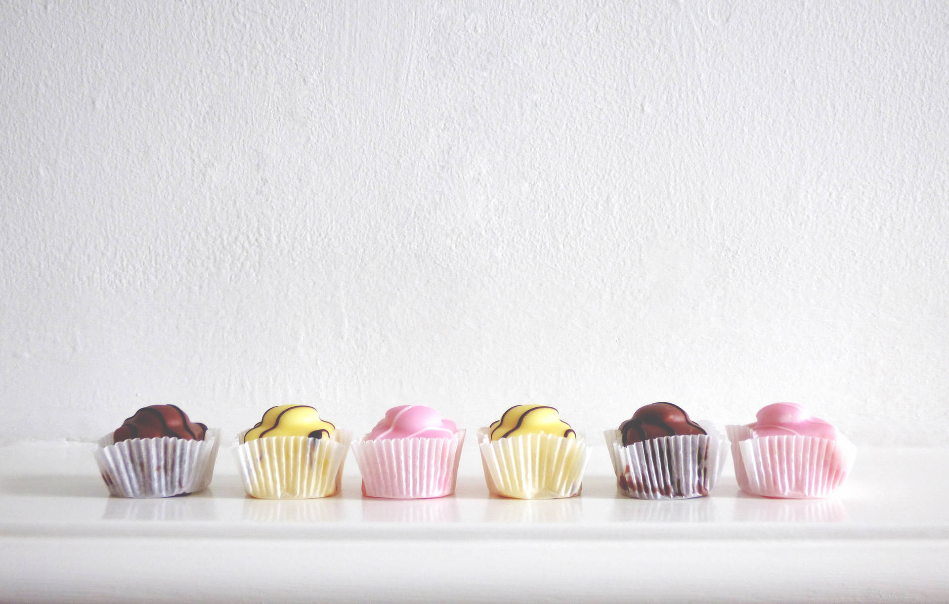 Colorful Cupcakes On White Background Background
