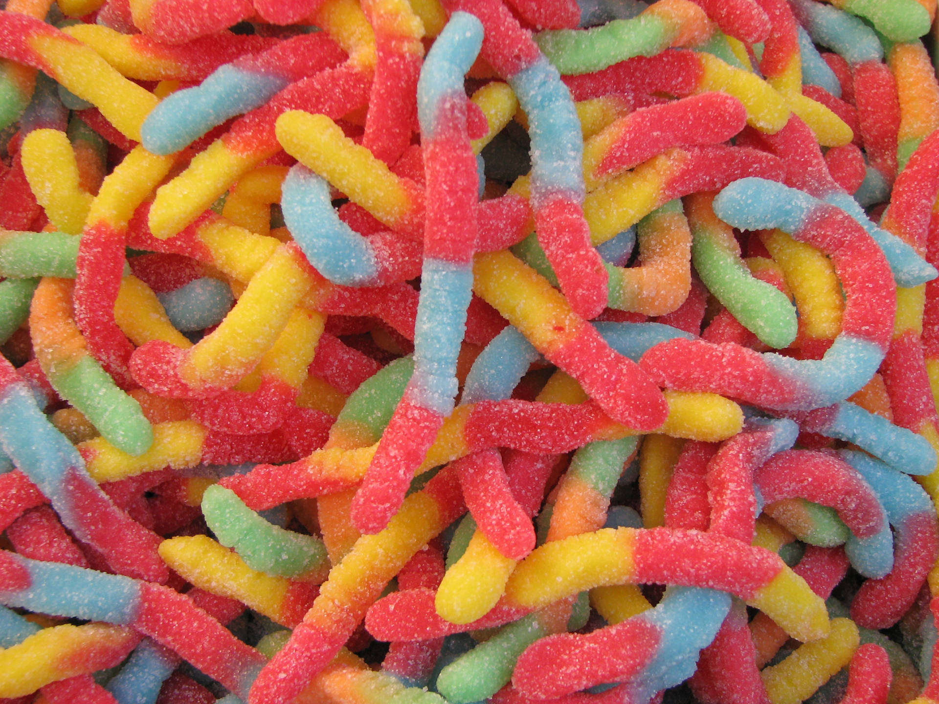 Colorful Feast Of Gummy Worm Candies Background