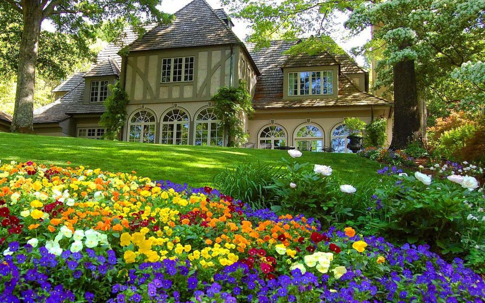 Colorful Flowers Near A Farmhouse Desktop Background