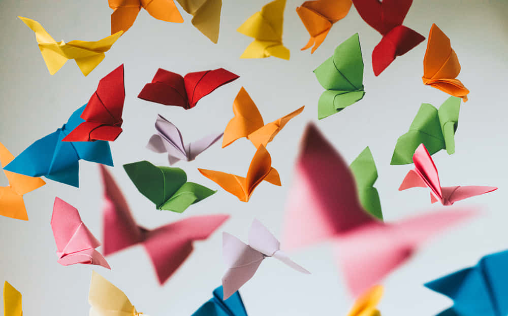 Colorful Origami Paper Birdsin Flight Background
