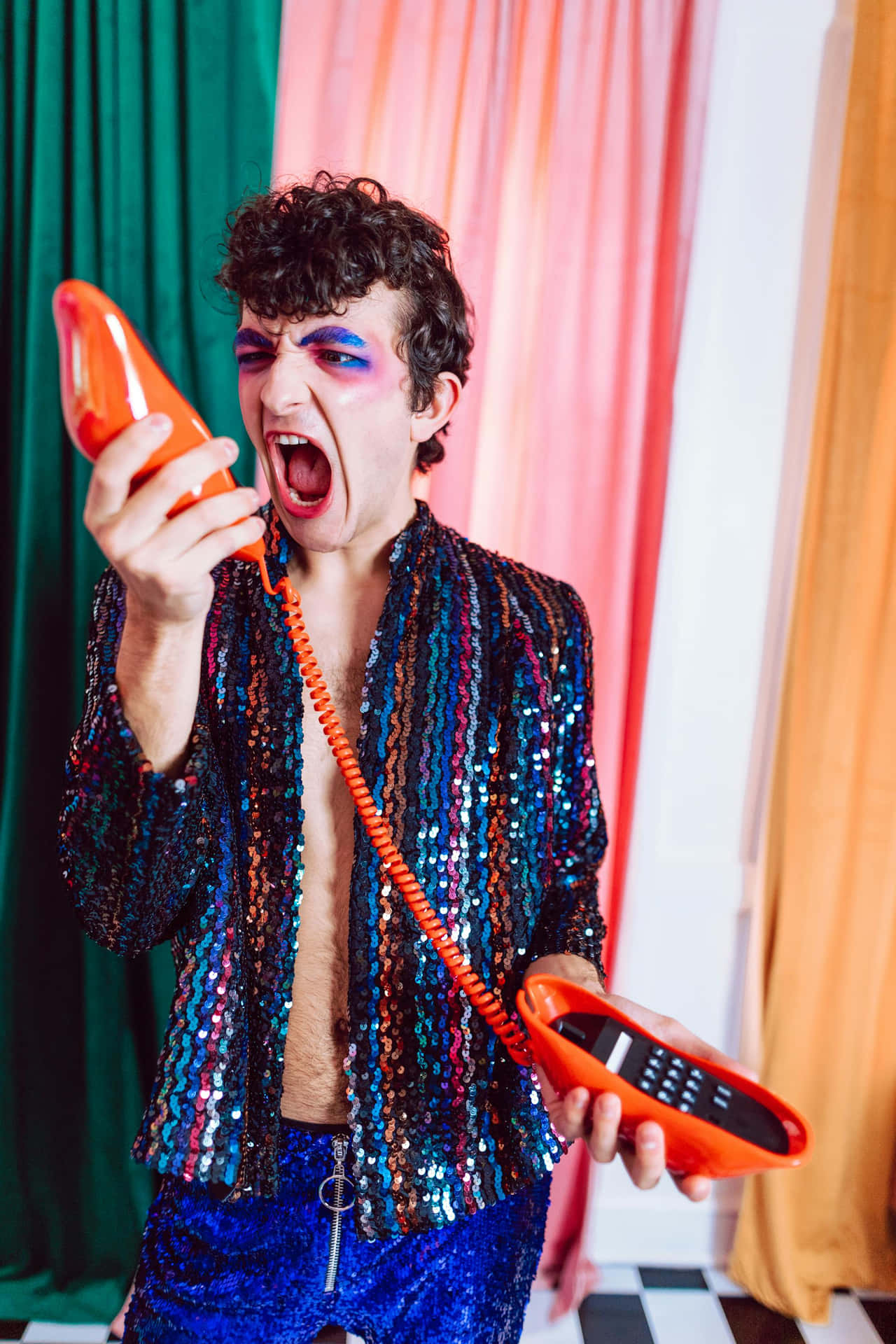 Colorful Outfit Man Yelling Into Phone Background