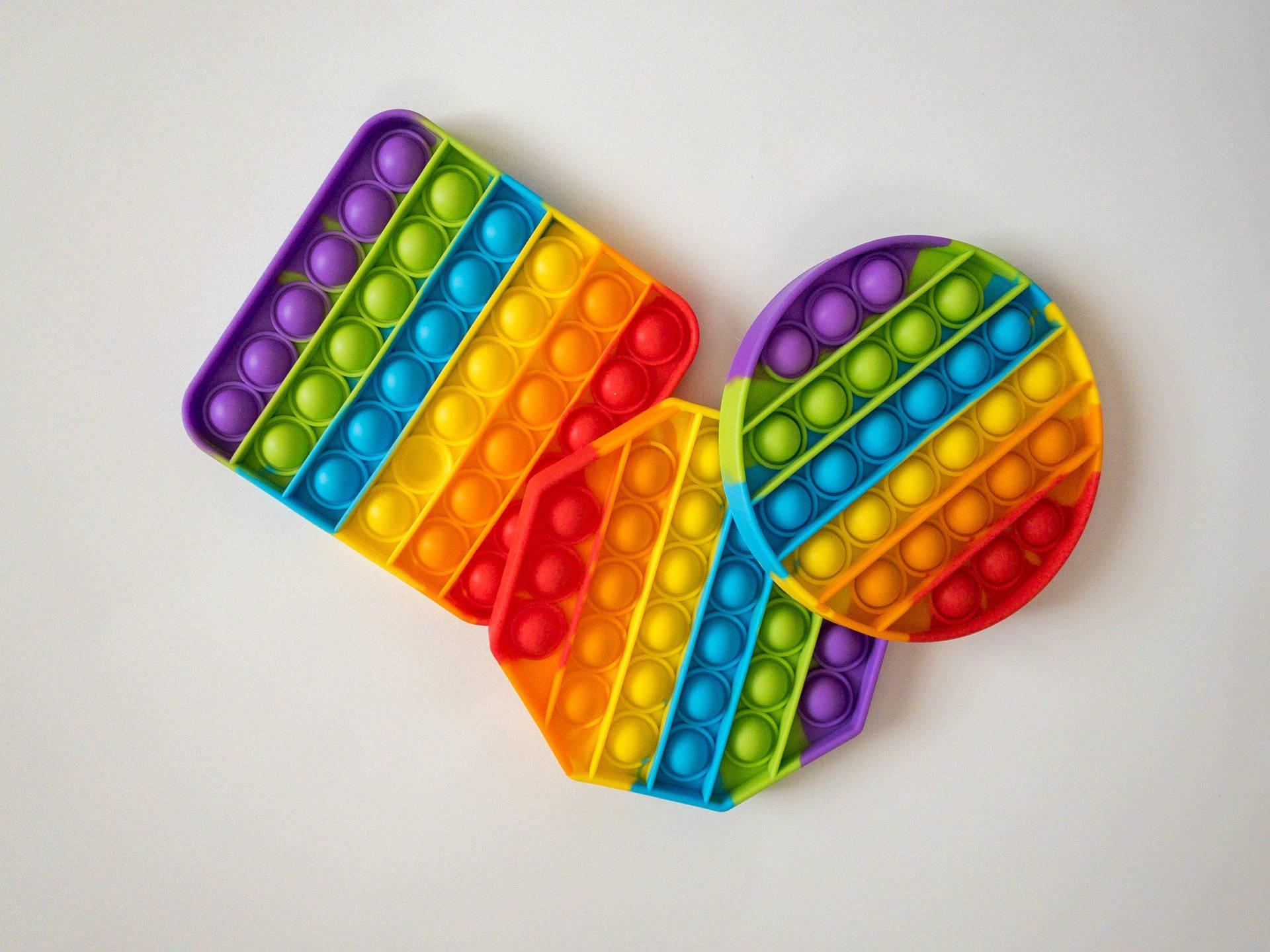 Colorful Pop It Fidget Toys In Various Shapes Background