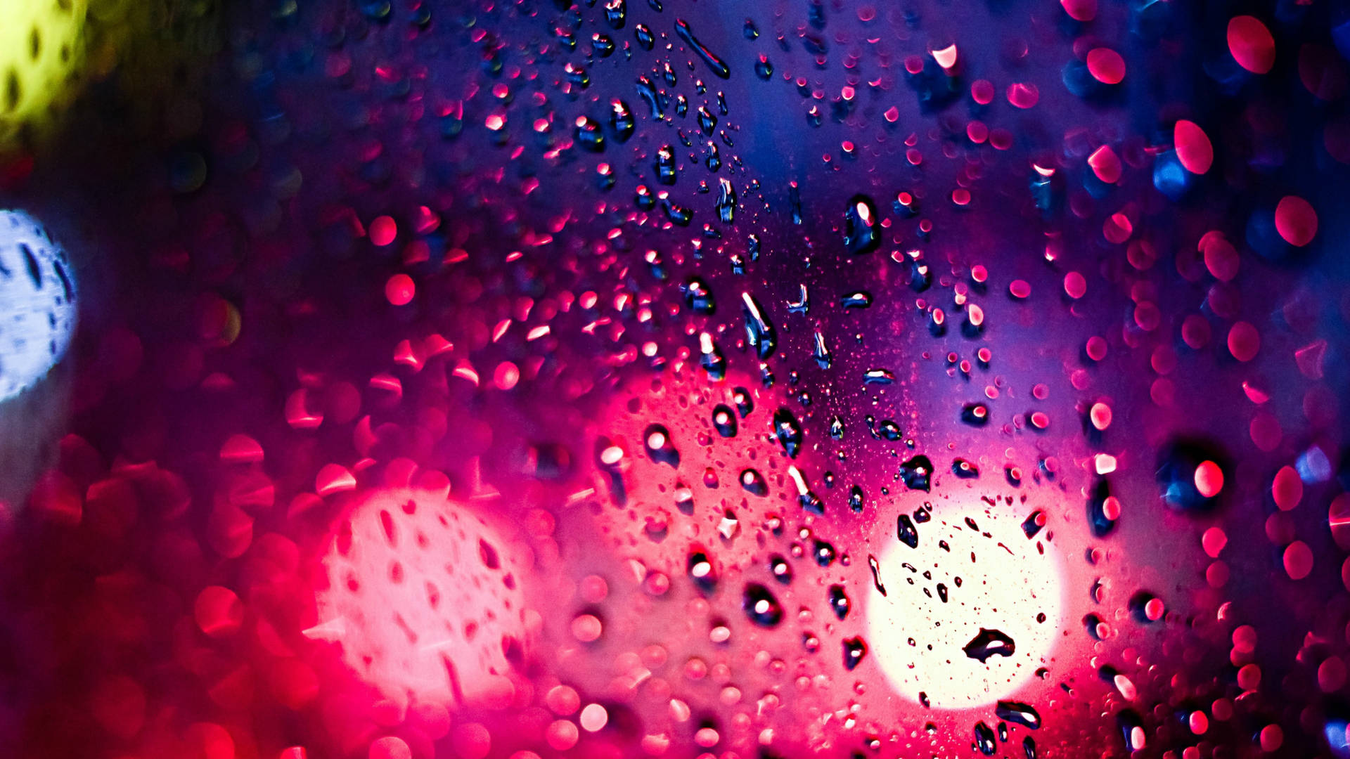 Colorful Raindrops On A Glass Surface