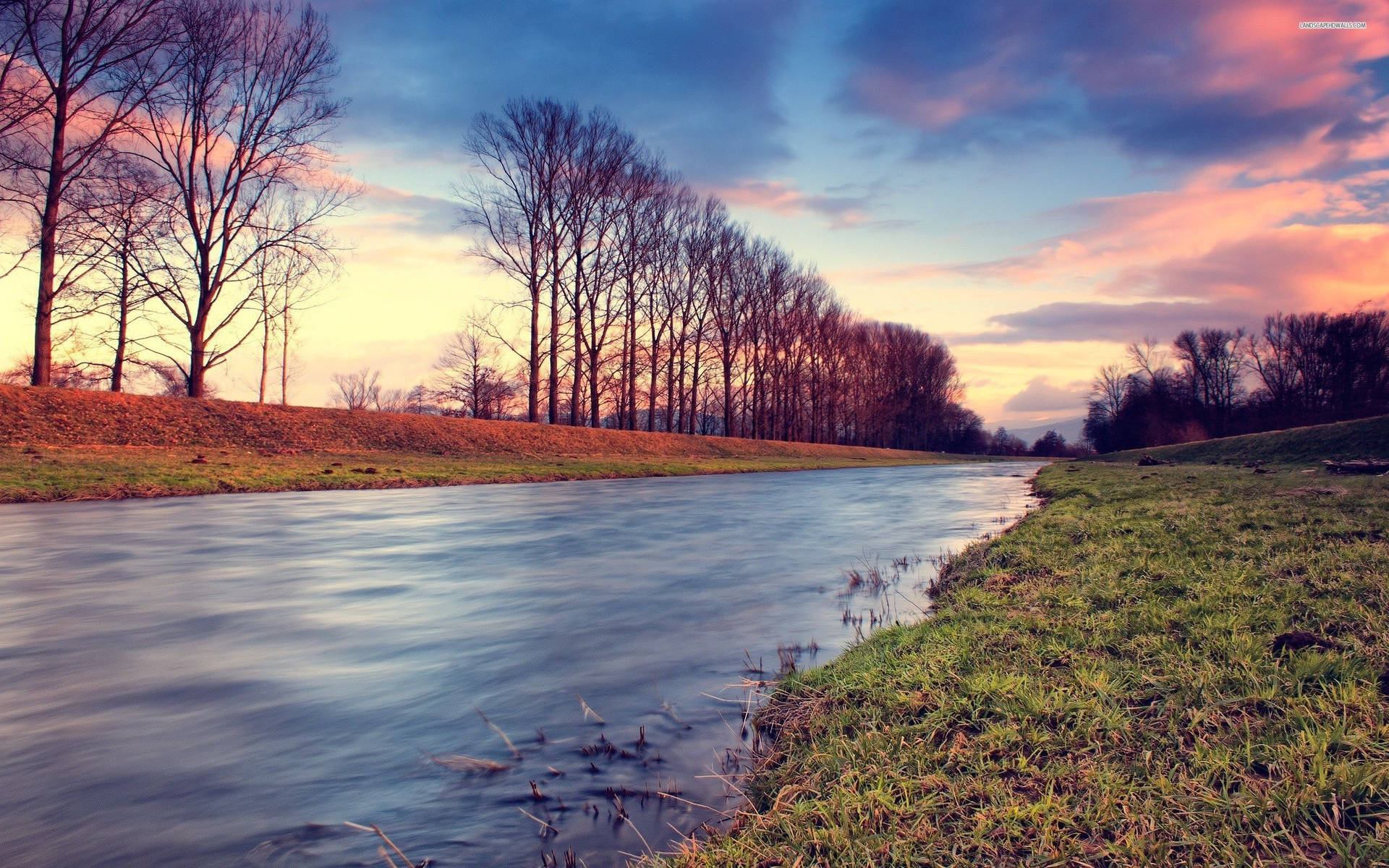 Colorful Skies Over The Riverside Background