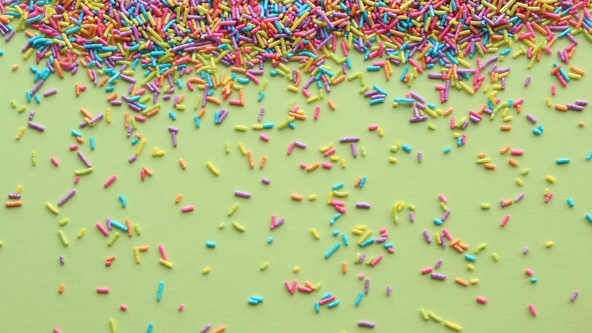 Colorful Sprinkleson Green Background Background