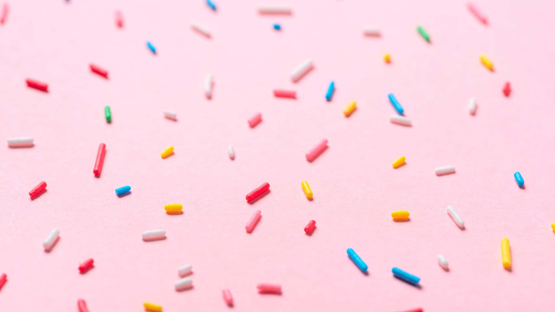 Colorful Sprinkleson Pink Background Background