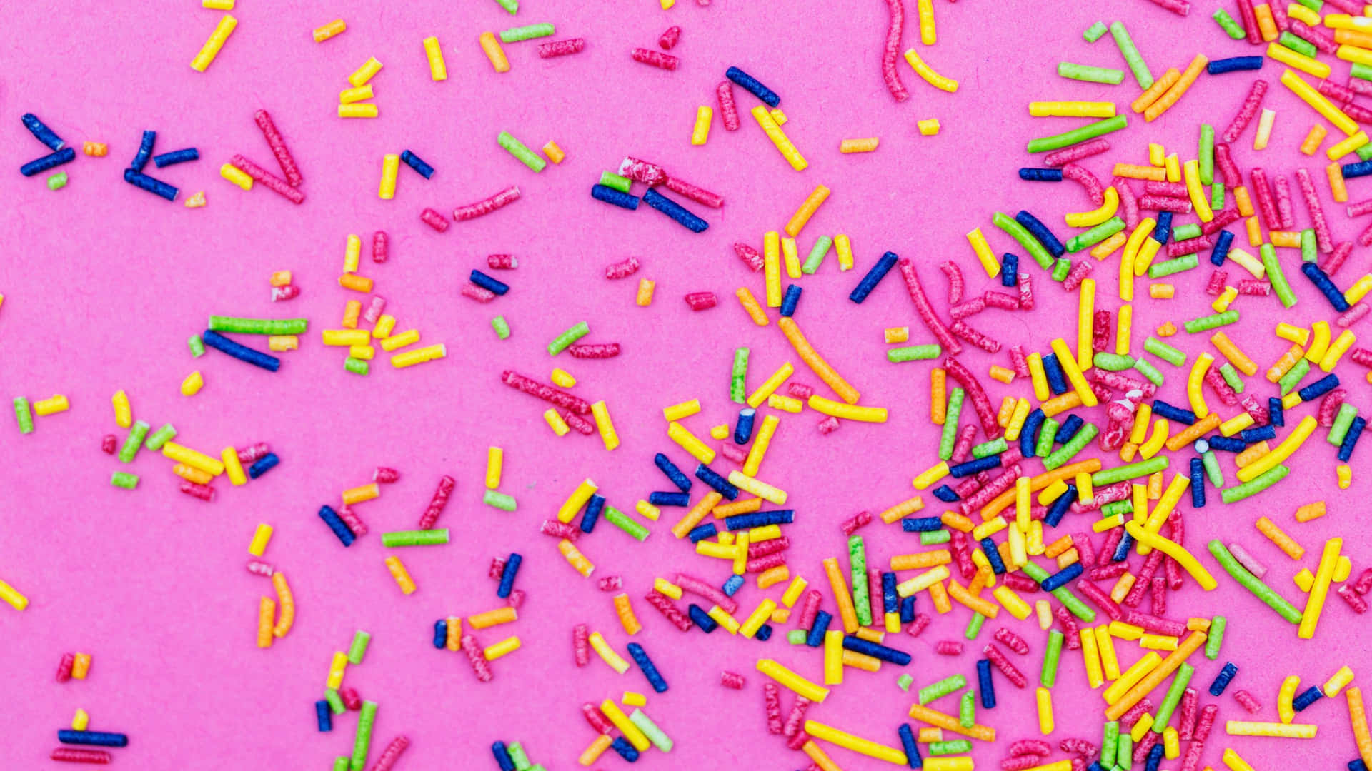 Colorful Sprinkleson Pink Background Background