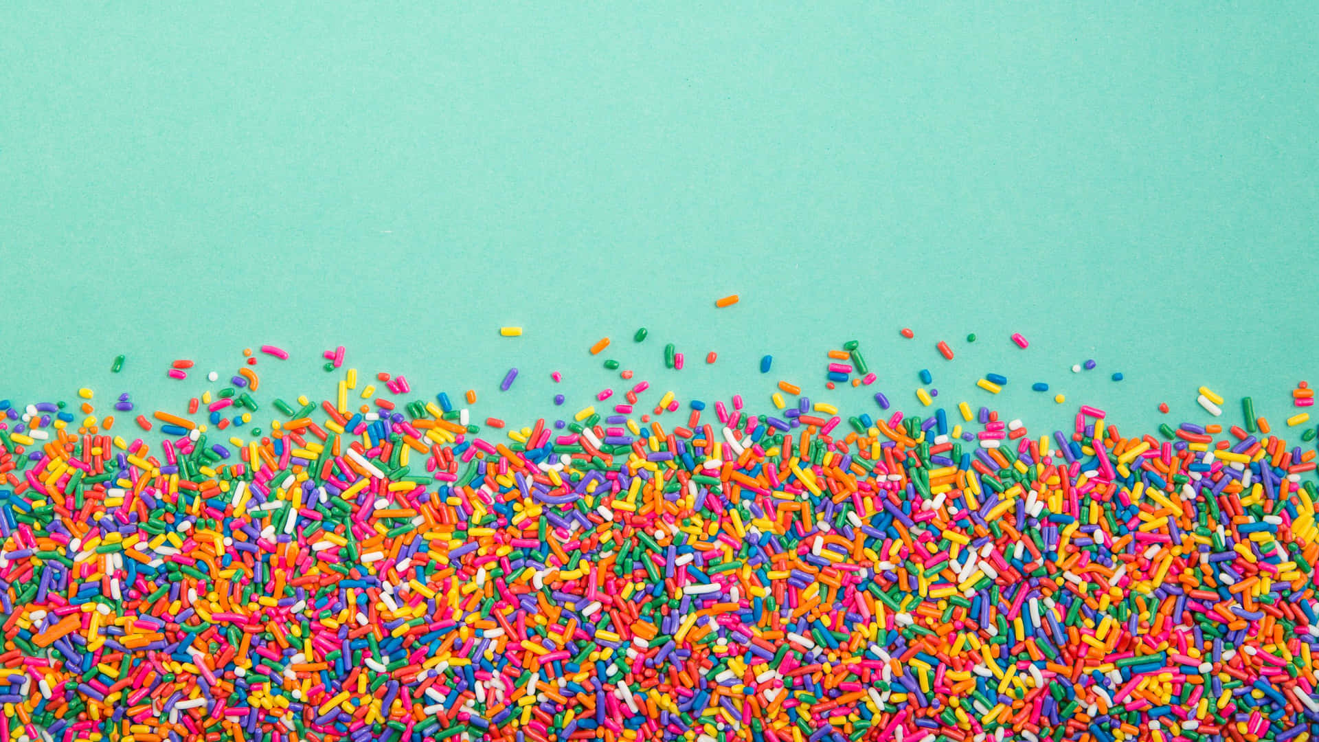 Colorful Sprinkleson Teal Background.jpg Background