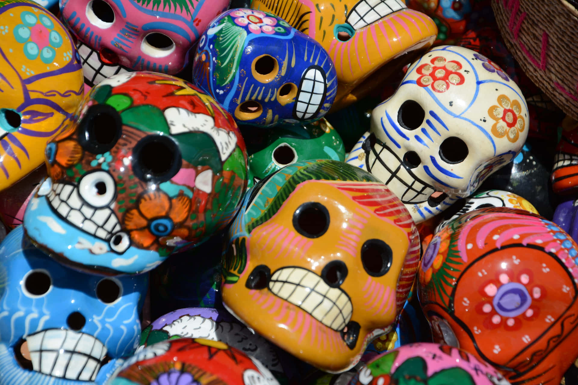 Colorful Sugar Skulls Are Arranged In A Basket Background