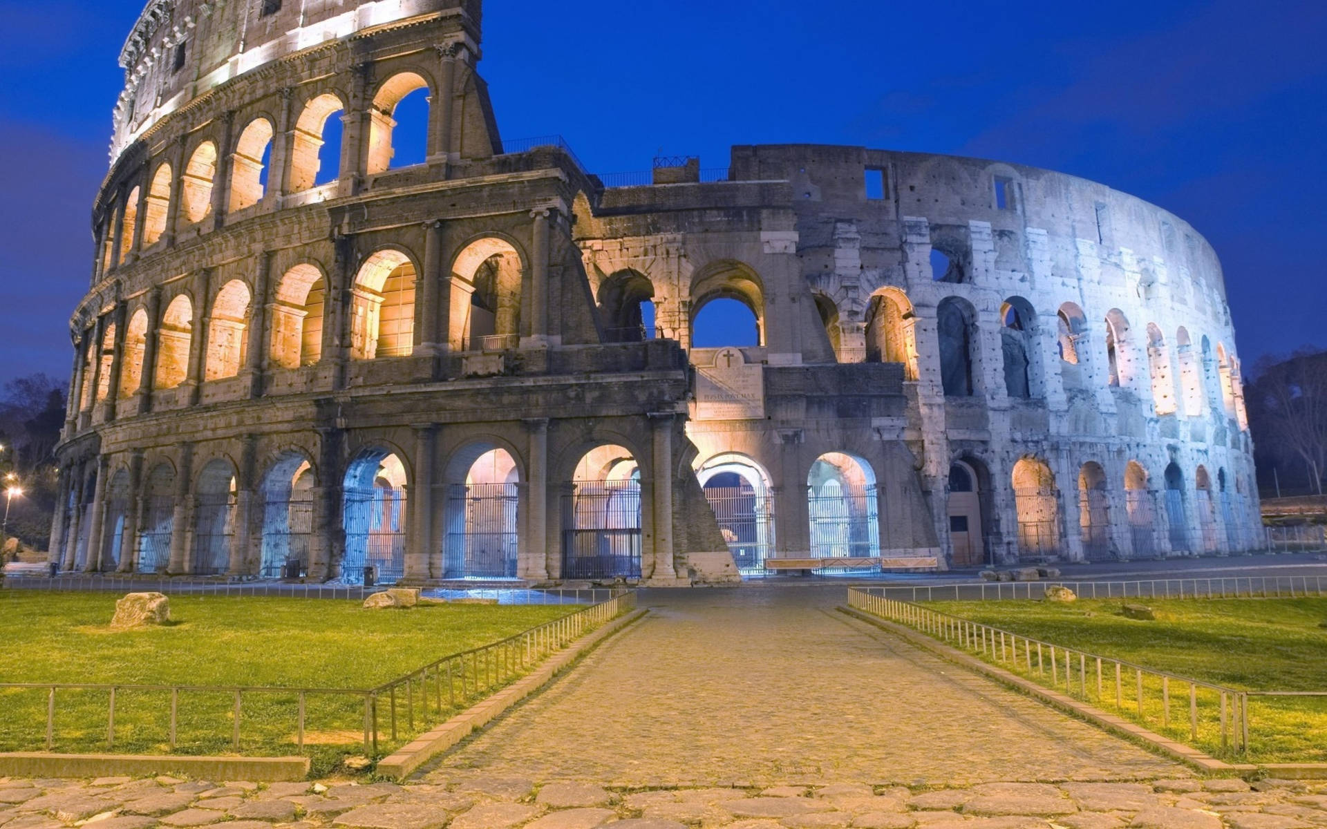 Colosseum At Night With Lit Arches Background