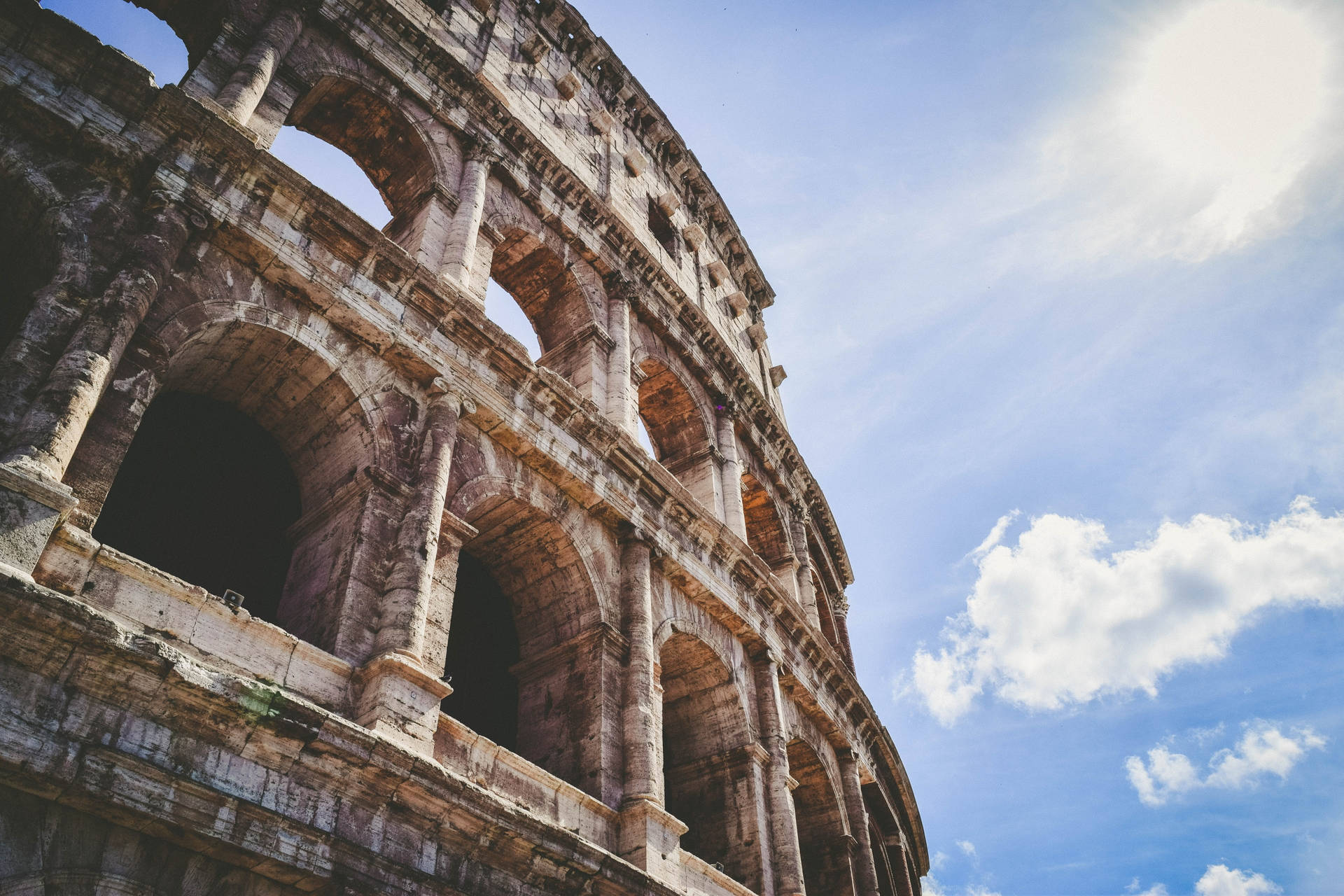 Colosseum Facing The Sun Background