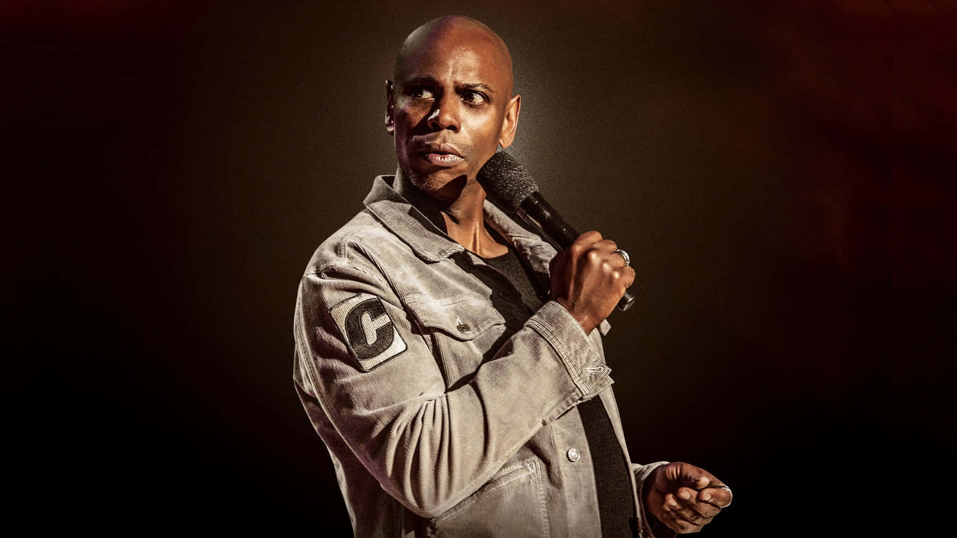 Comedian Dave Chappelle Performing On Stage Background