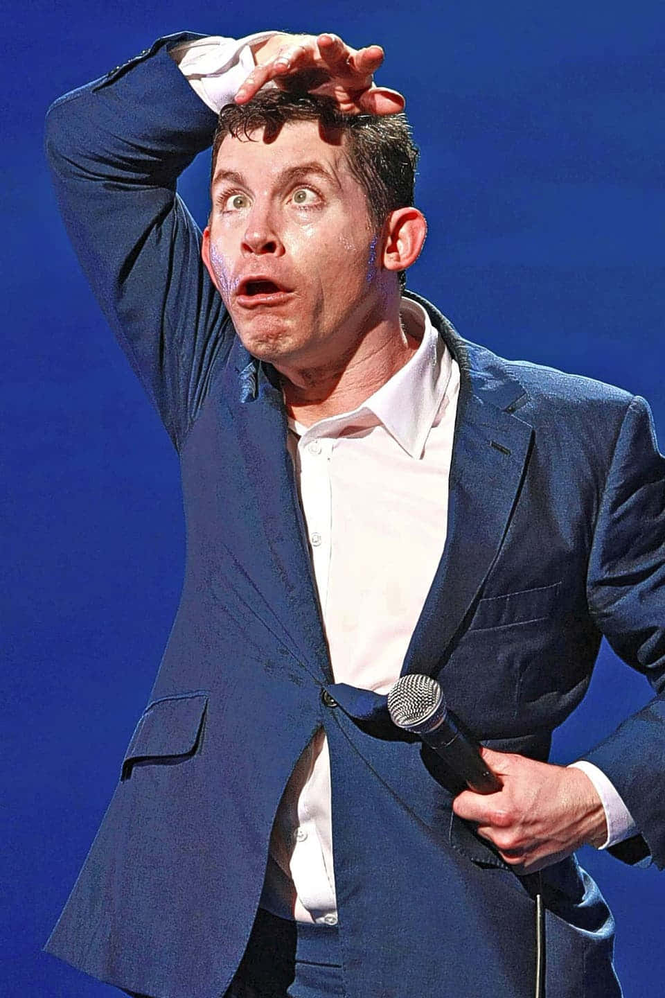 Comedian Lee Evans On Stage Background