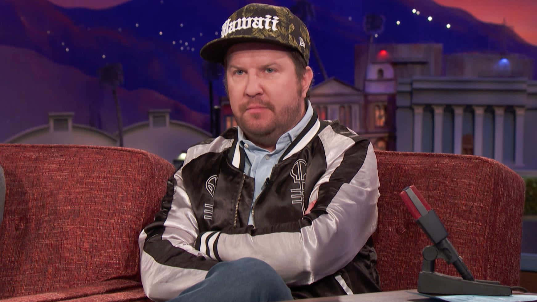 Comedian Nick Swardson Performing On Stage Background