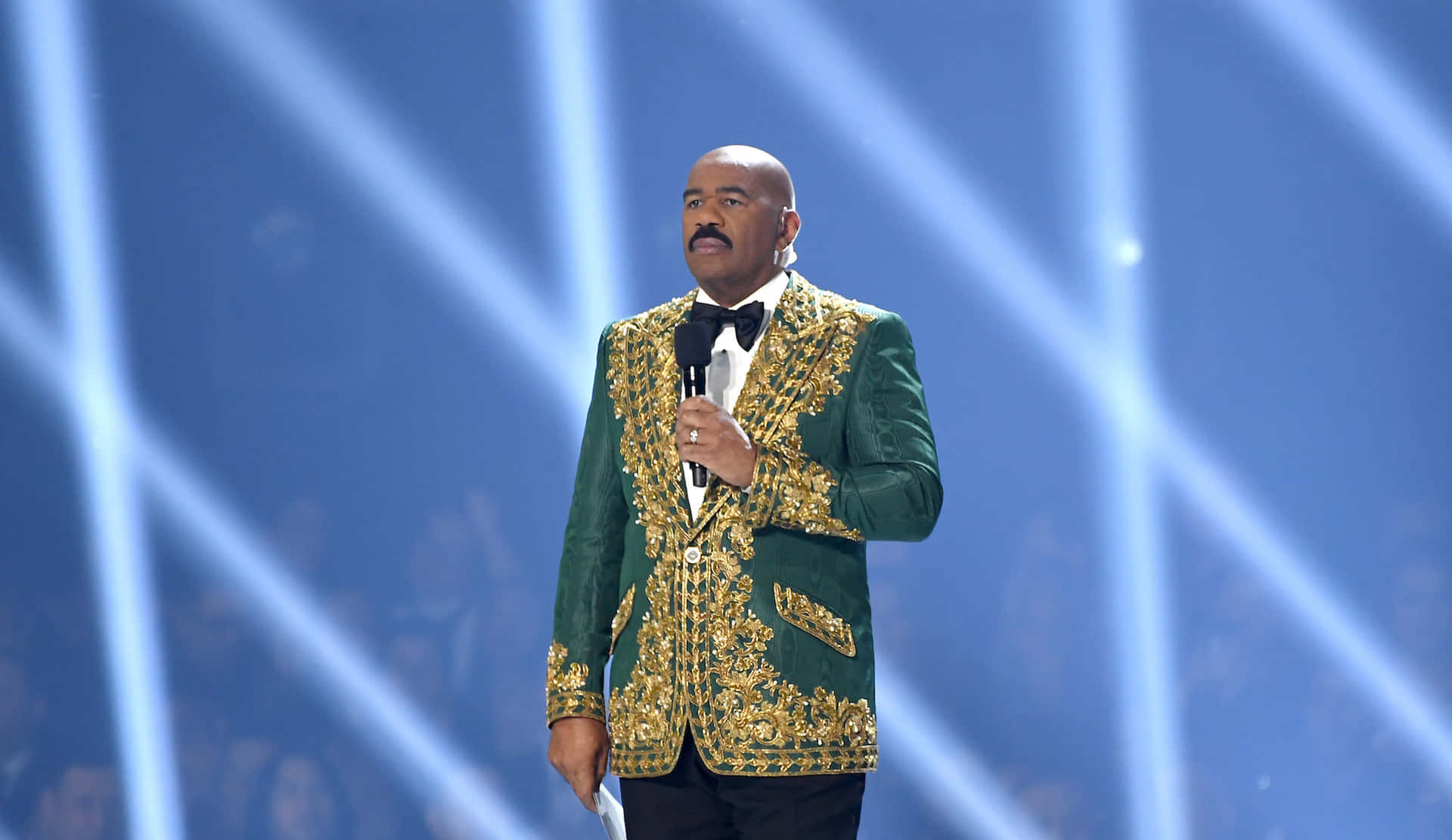 Comedian Steve Harvey During His Charismatic Performance On Stage. Background