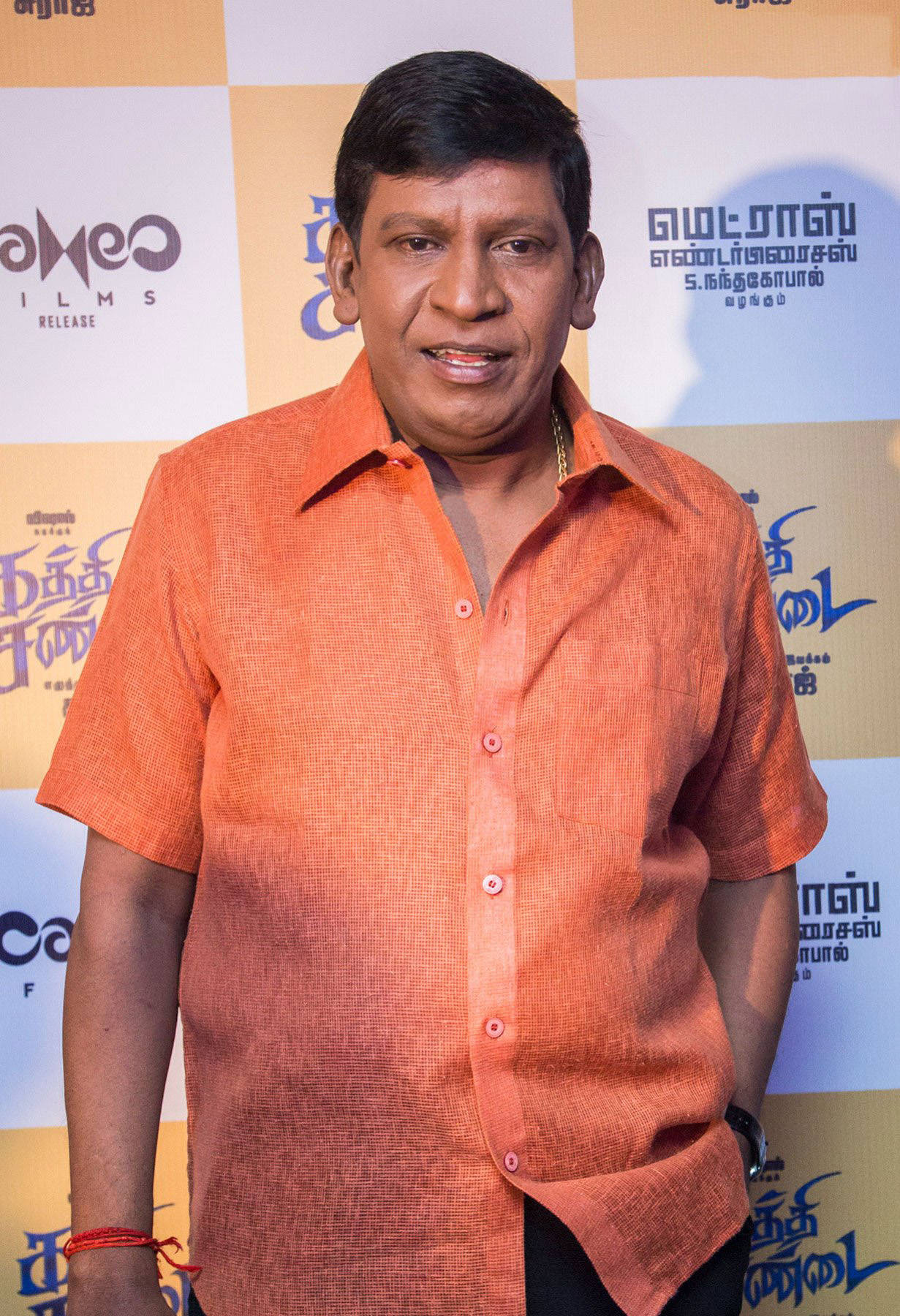 Comedian Vadivelu In Orange Background