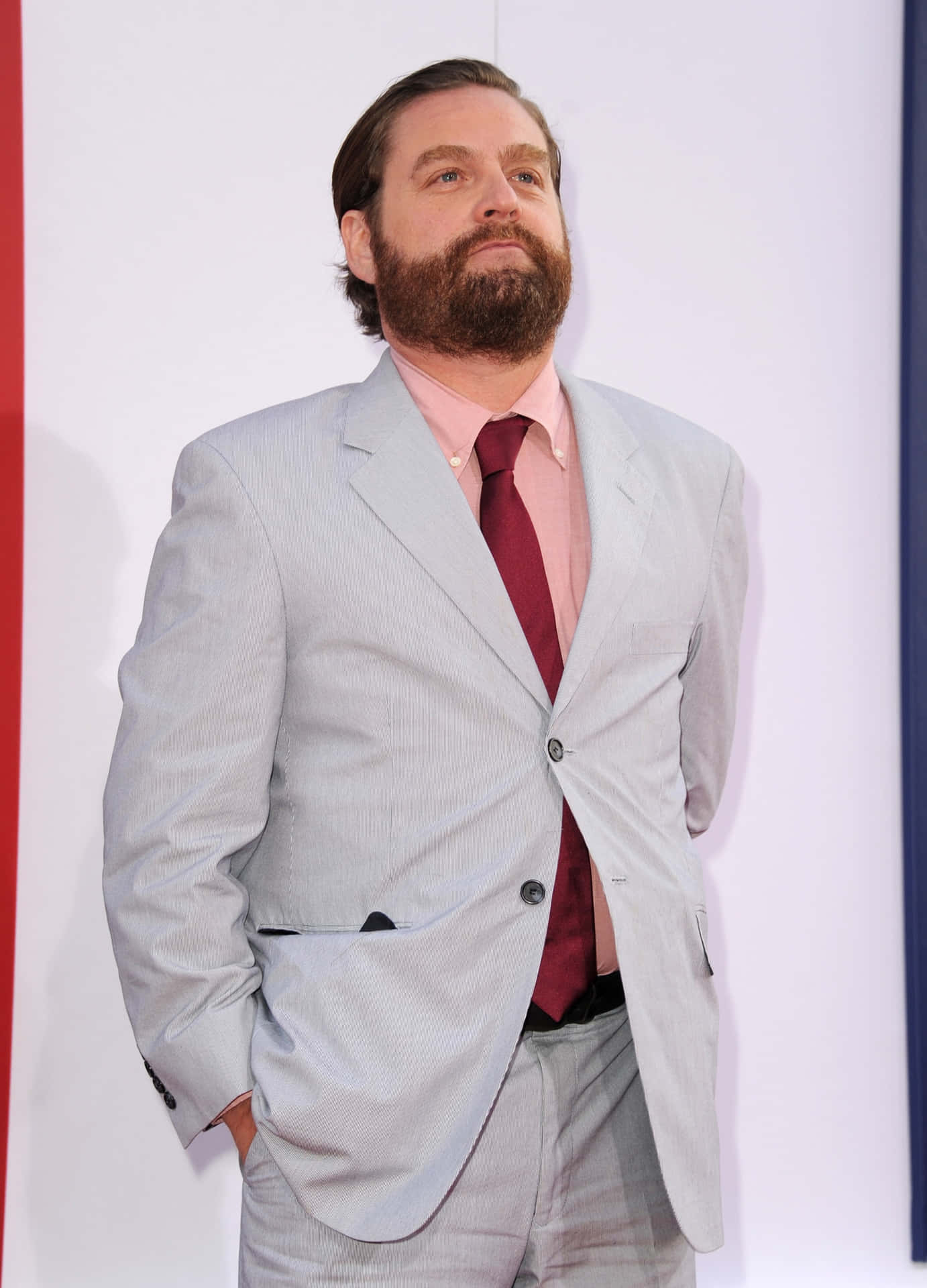 Comedian Zach Galifianakis Enjoying A Laugh Background