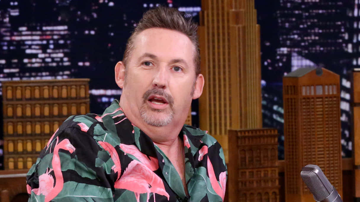 Comedianin Flamingo Shirt During Interview Background