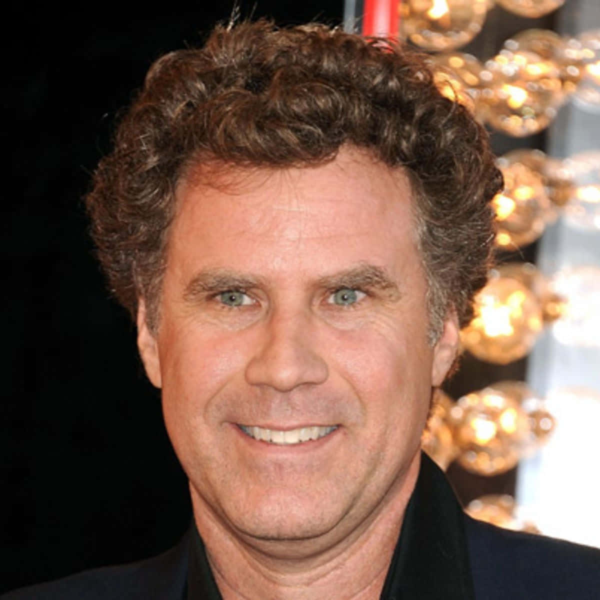 Comedic Genius Will Ferrell Smiling In A Suit And Tie Background