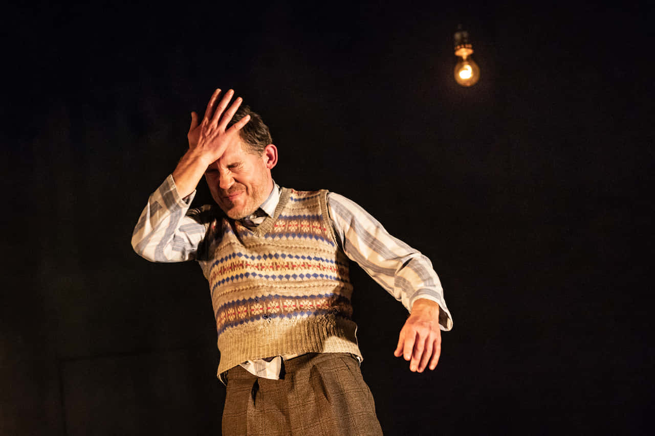 Comedic Performance Under Spotlight Background