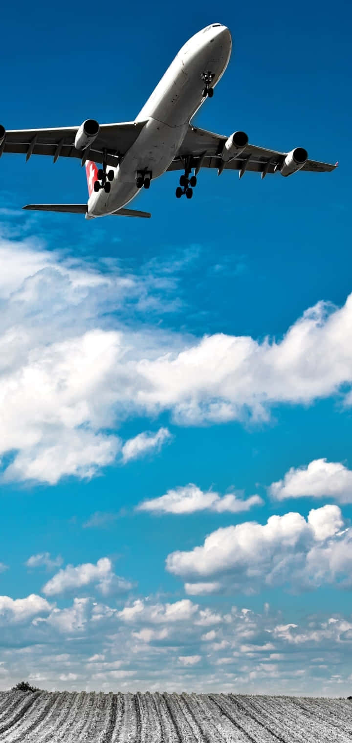 Commercial Airplane Ascending Above Clouds Background