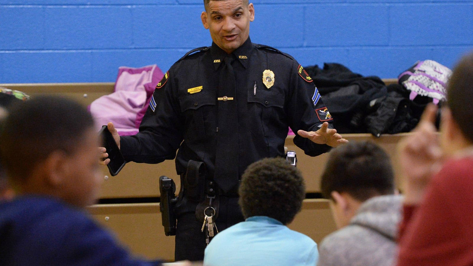 Community Engagement - Police Officer Tom Lenox Interacting With Local Kids Background