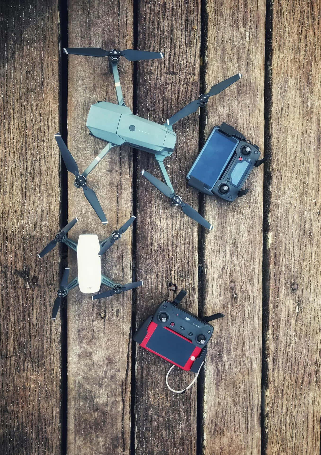 Compact Droneand Controlleron Wooden Background.jpg