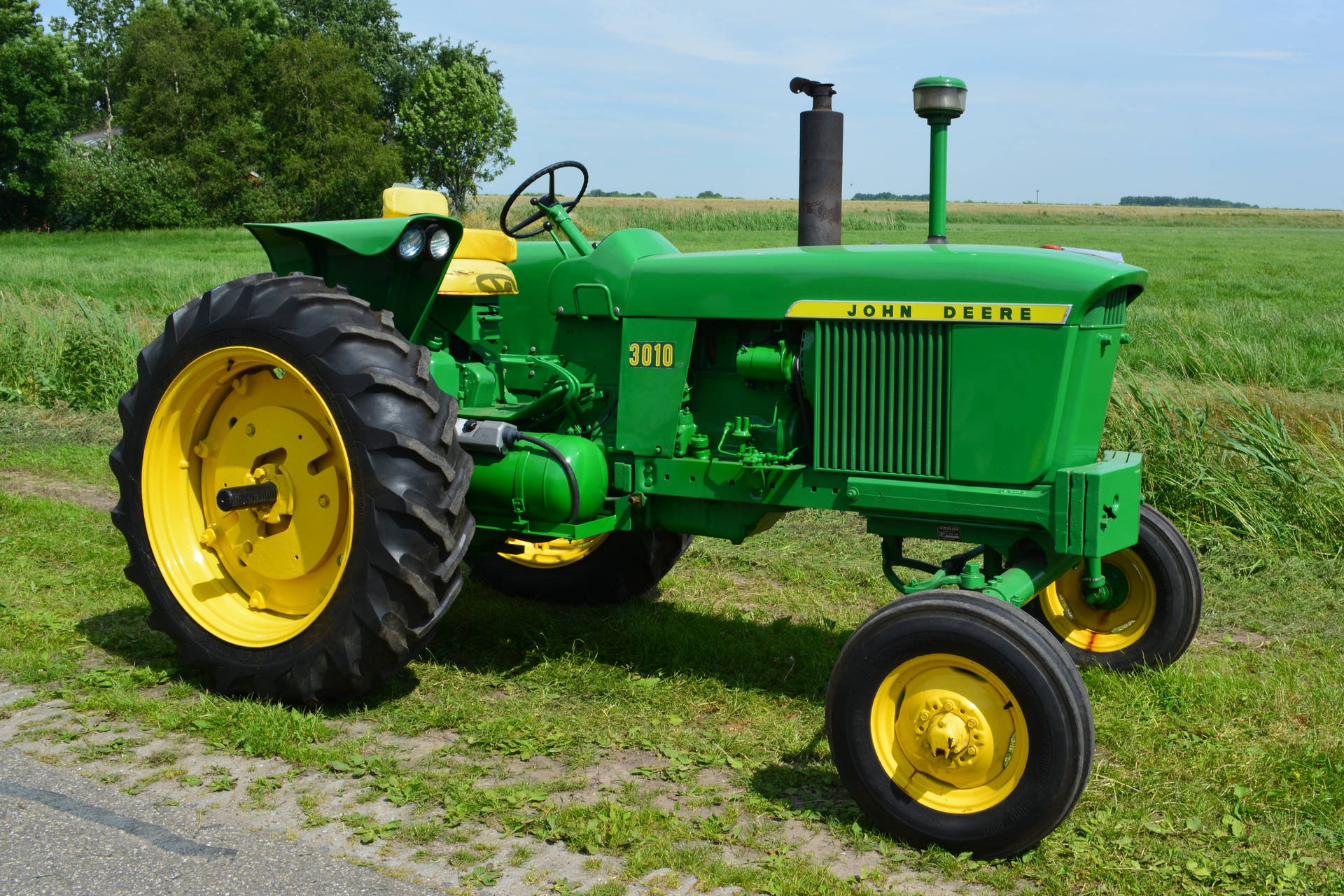 Compact Yet Powerful John Deere Tractor In Action Background