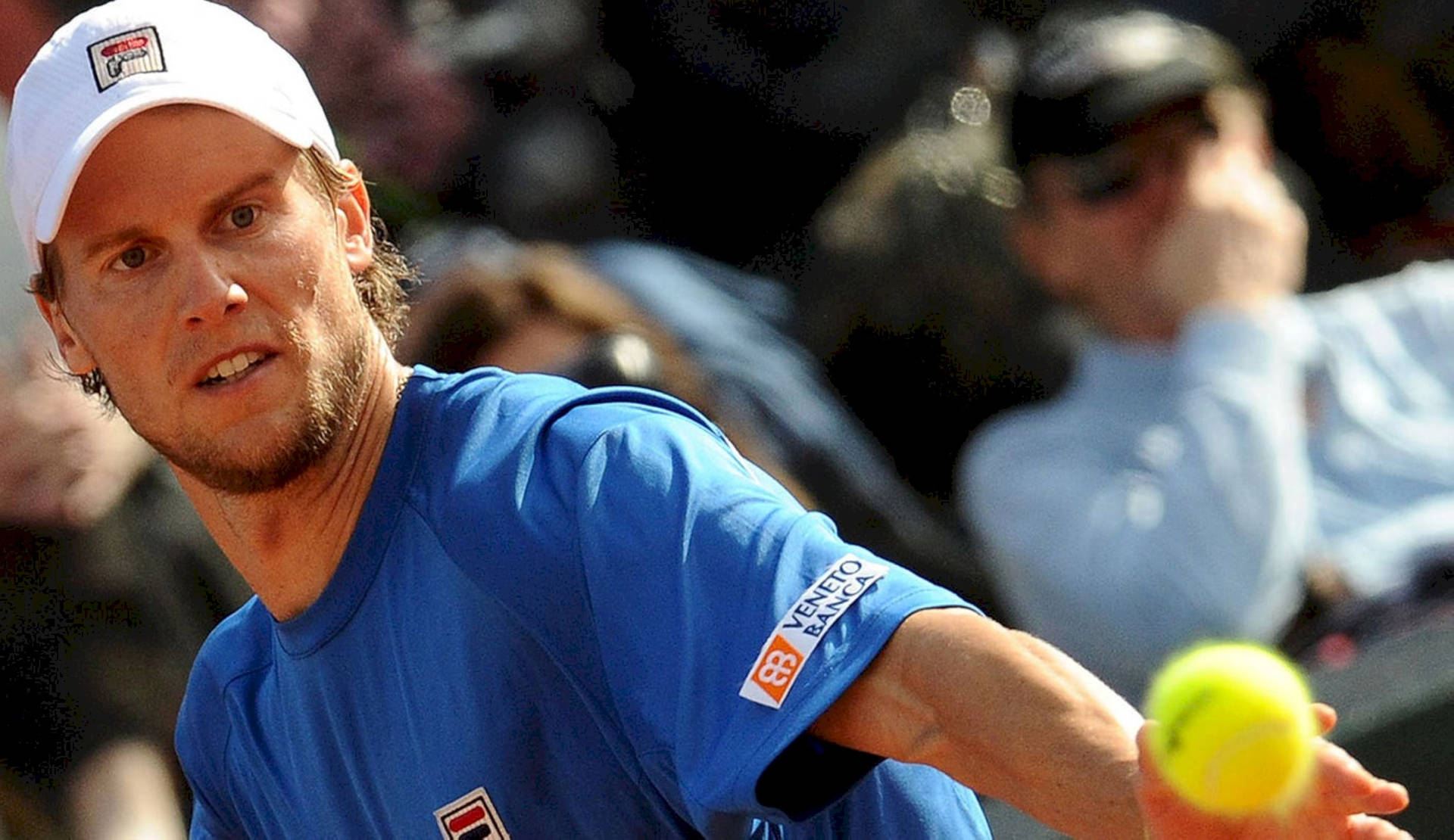 Competent Tennis Player Andreas Seppi Aiming At The Ball Background