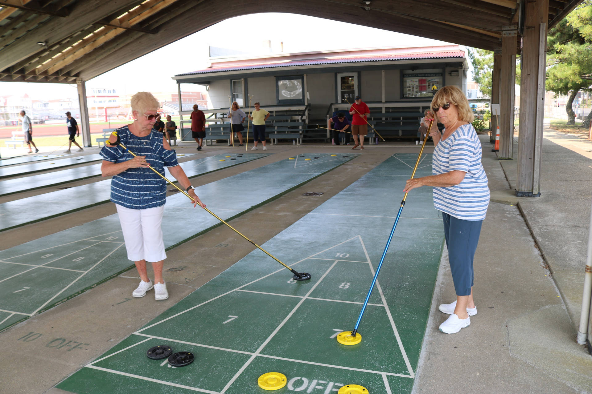 Competitive Shuffleboard Tournament In Ocean City Background