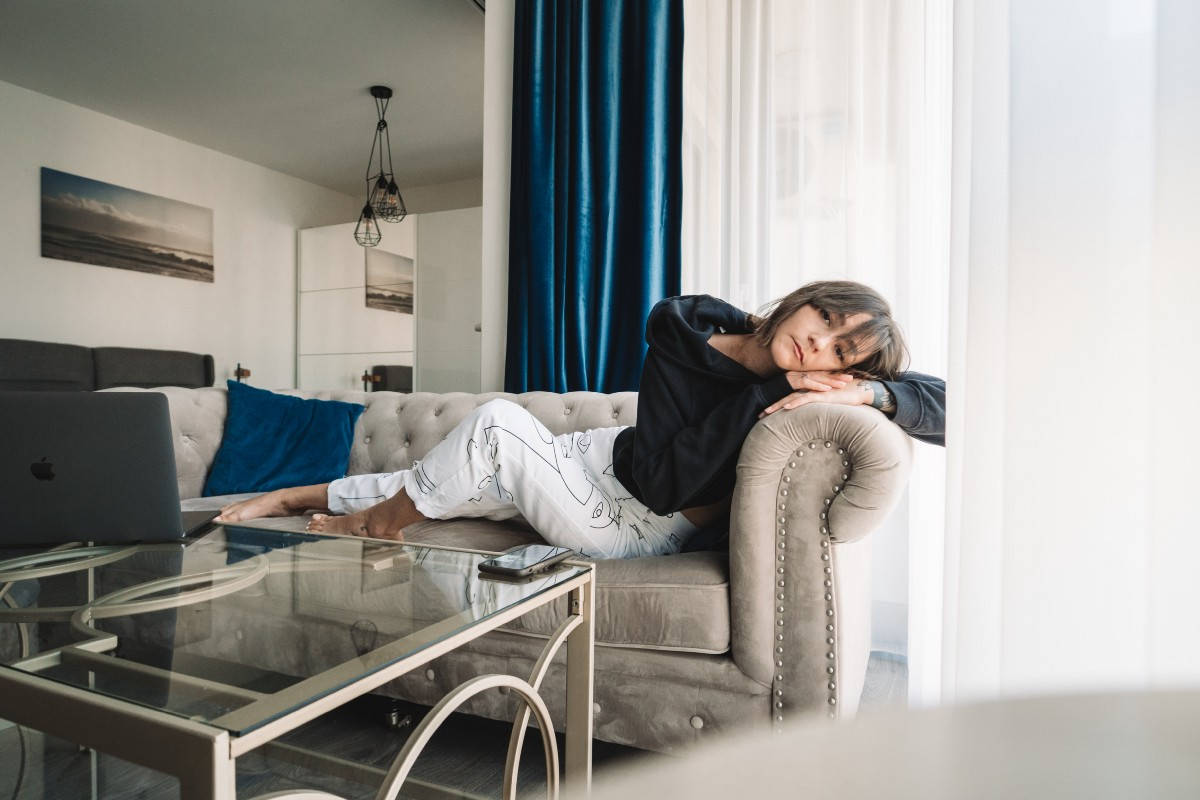 Complacent Girl Relaxing On Couch Background