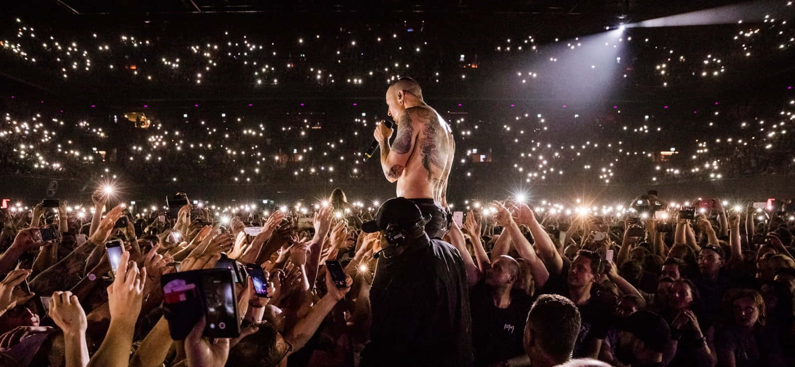 Concert Crowd Illuminatedby Cellphones Background