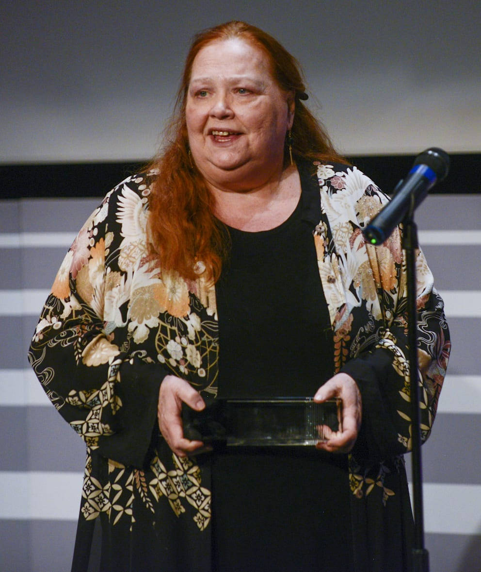 Conchata Ferrell Speaking On Stage Background