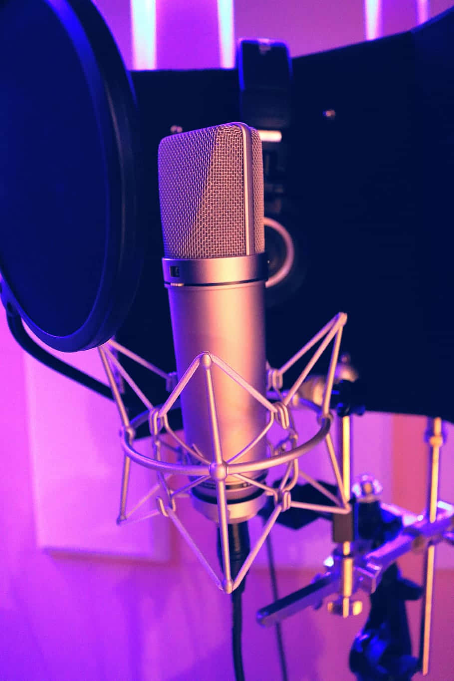 Condenser Microphone In The Studio With Neon Lights Background