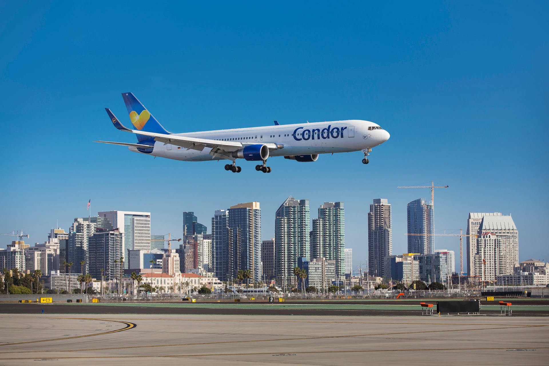 Condor Airlines Flying Above The Skyline Background