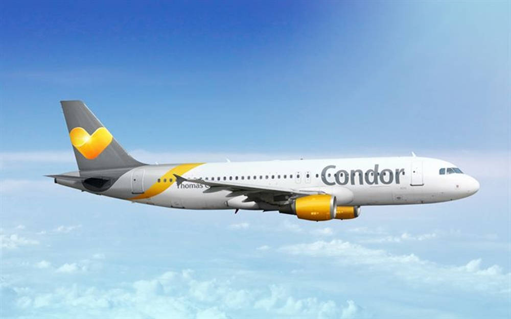 Condor Airlines Flying Airplane Above Clouds Background