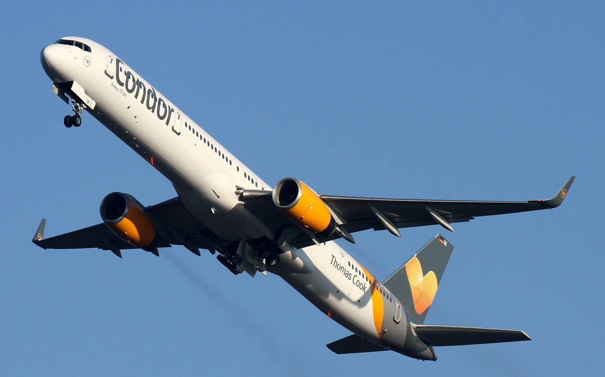 Condor Airlines Flying Airplane In Blue Sky Background