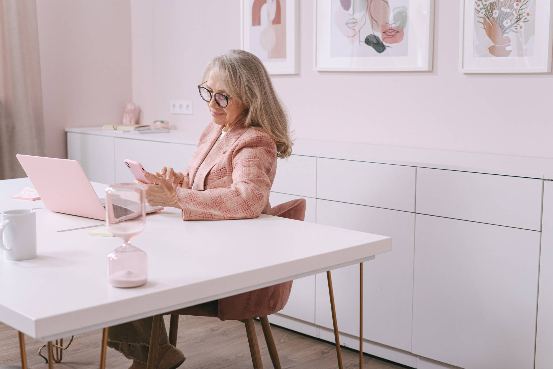 Confident Mature Woman In Pink Office Background