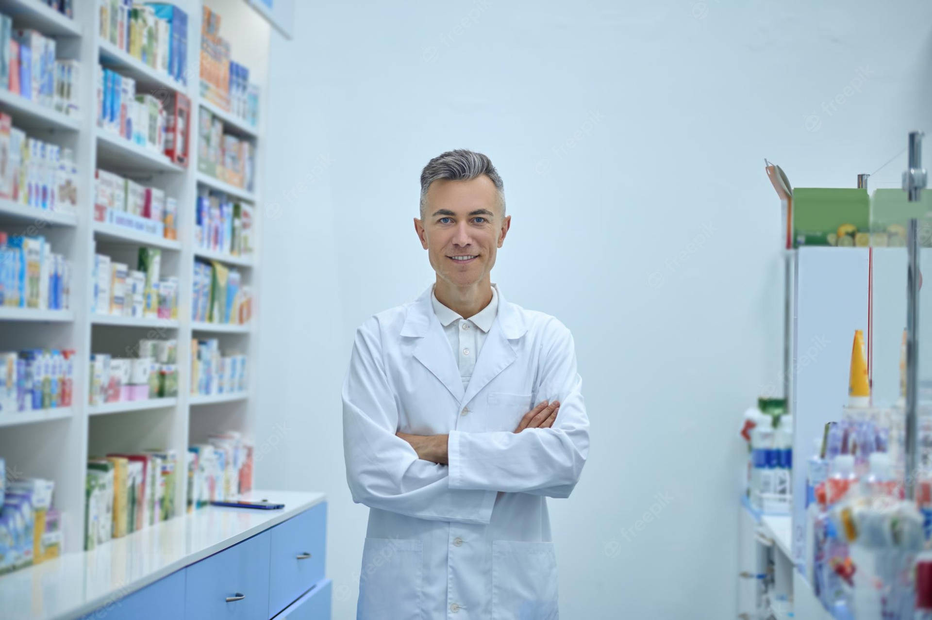 Confident Pharmacist In A White Lab Coat With Arms Folded Background