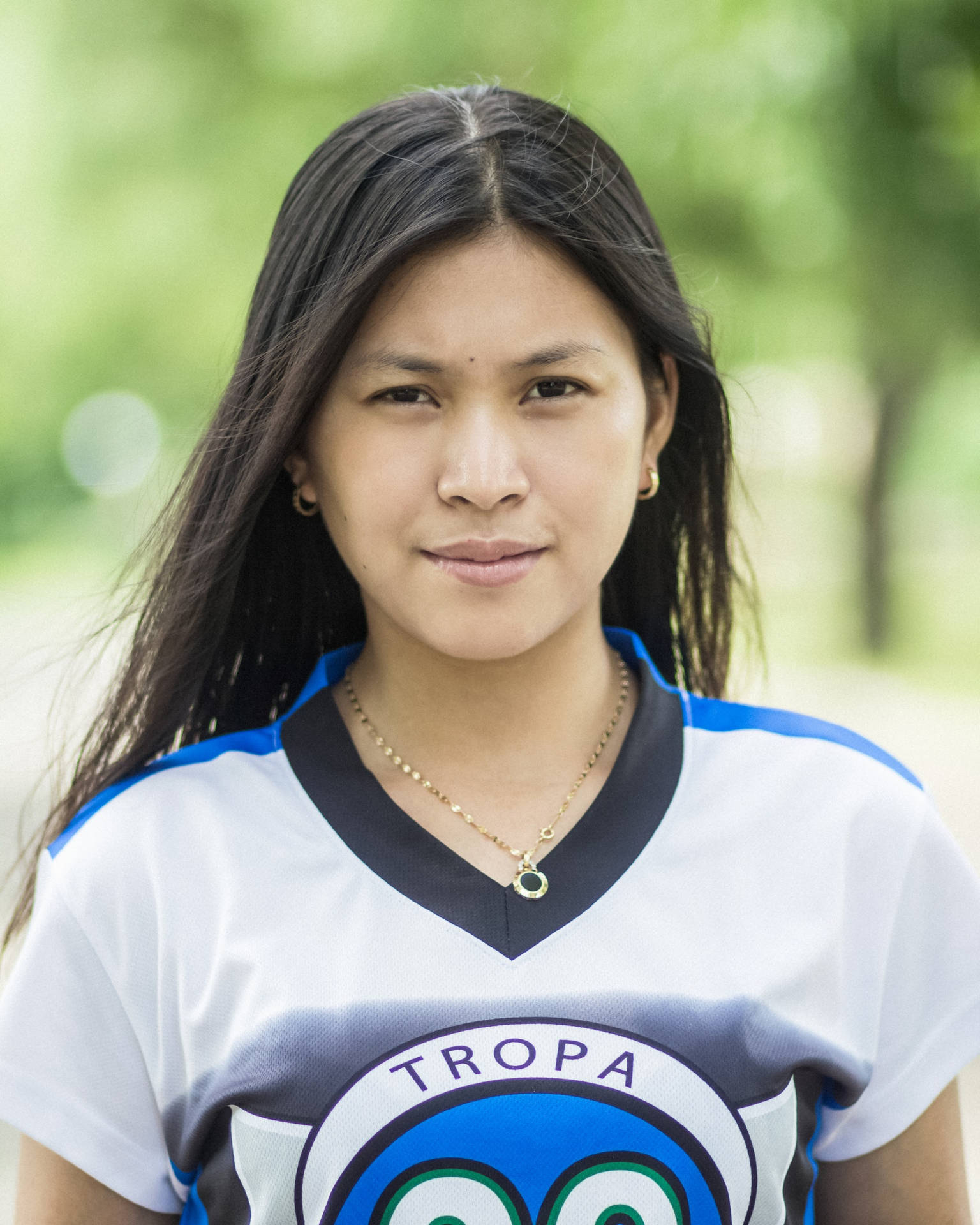 Confident Woman In Jersey Top Headshot Background