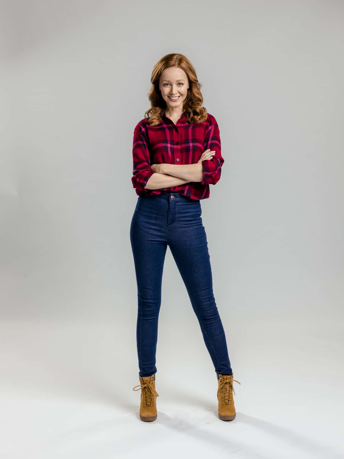 Confident Womanin Plaid Shirtand Jeans Background