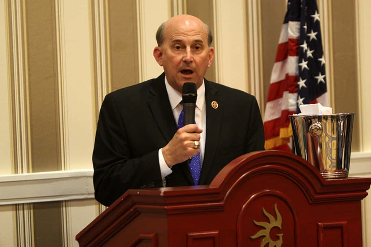 Congressman Louie Gohmert Passionately Speaking Into A Microphone Background