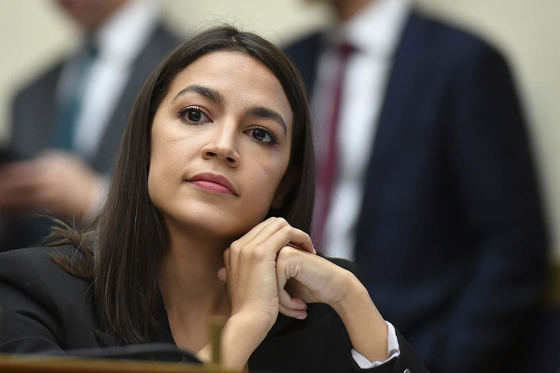 Congresswoman Alexandria Ocasio-cortez With United Hands Background