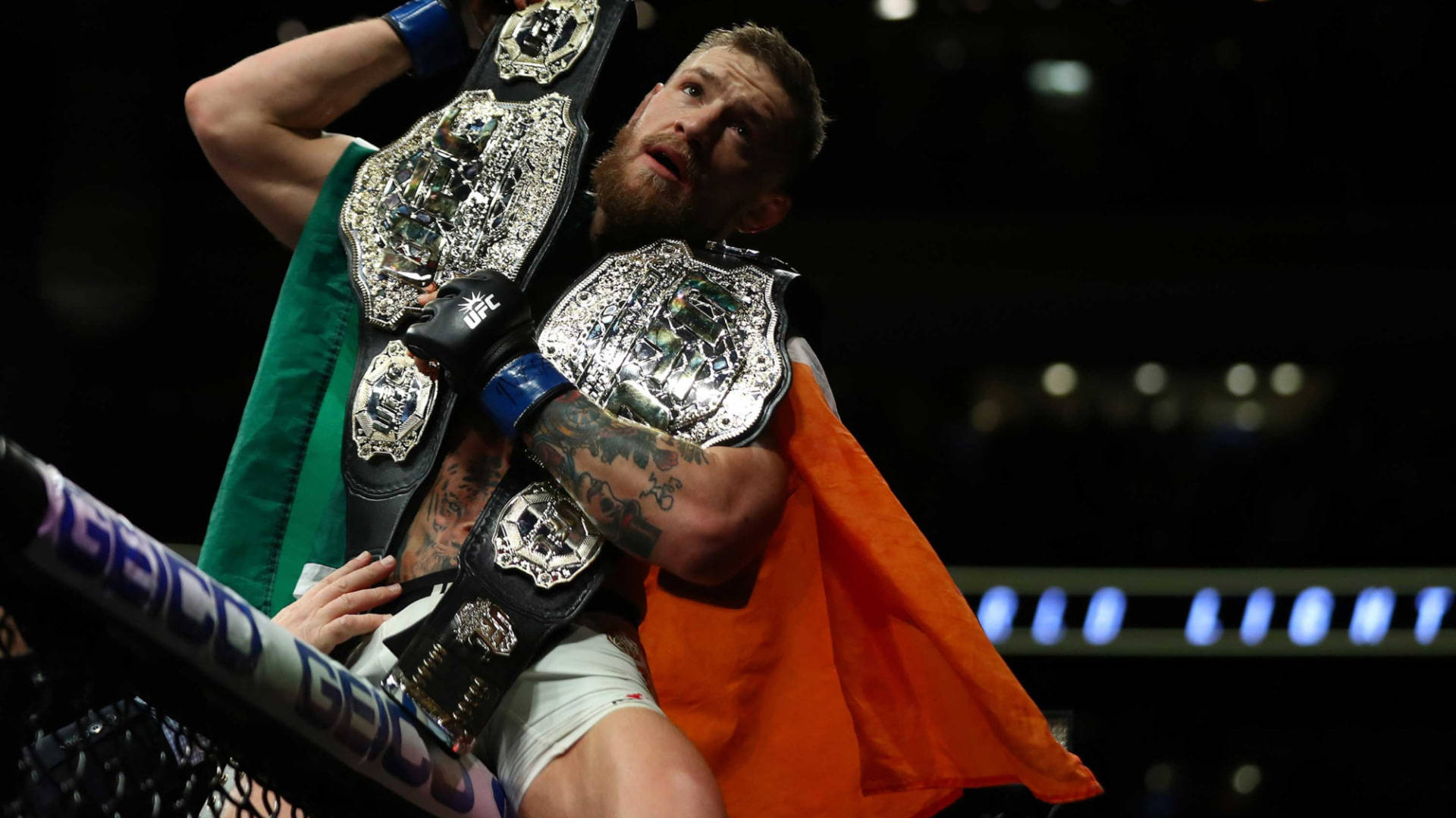 Conor Mcgregor With Two Ufc Belts Background