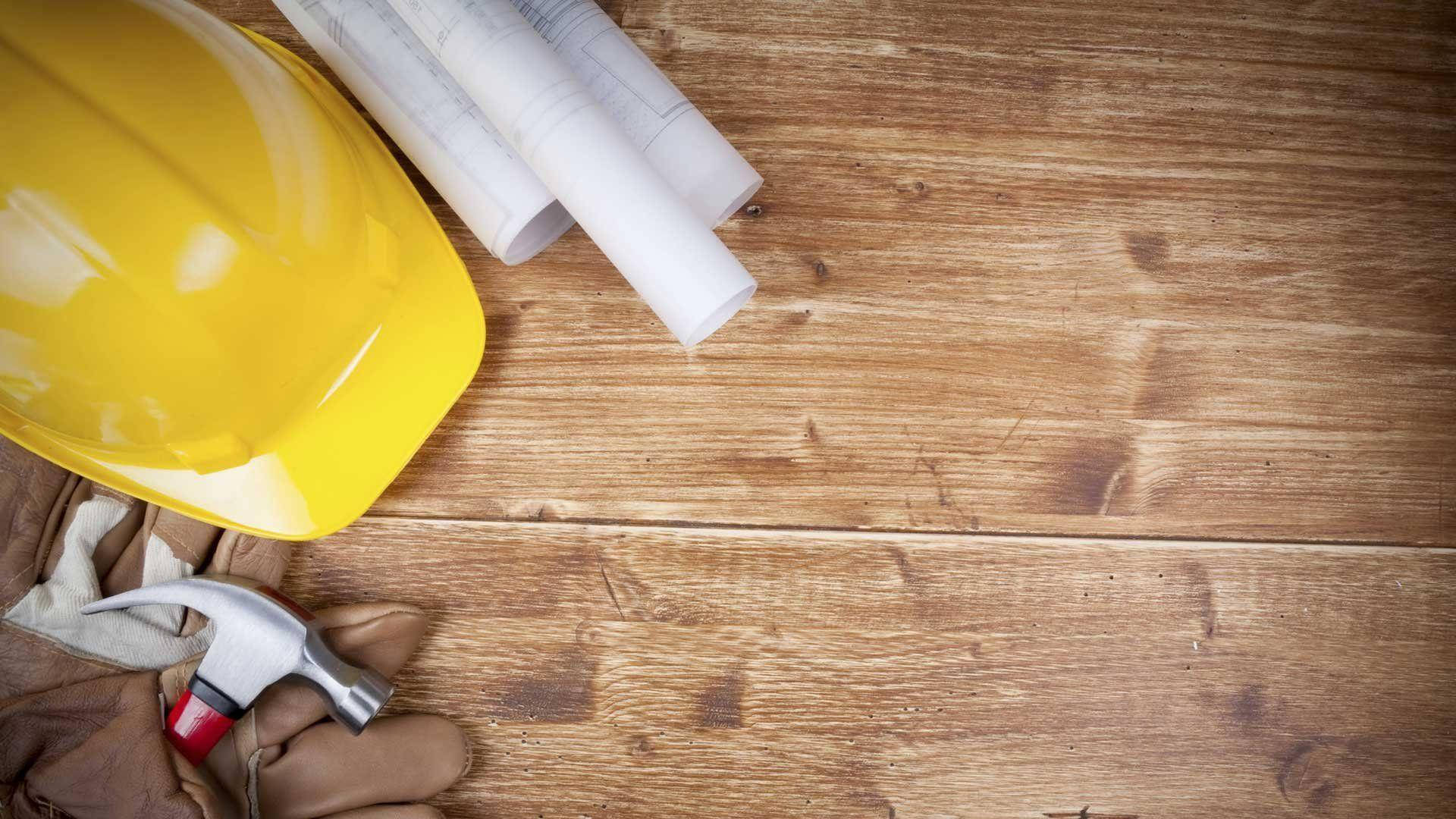 Construction Tools On A Wooden Surface Background