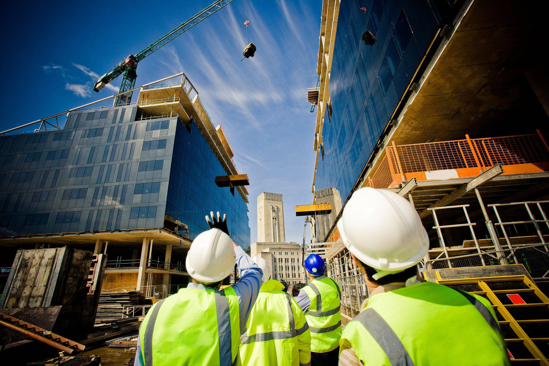 Construction Workers Looking Up At Crane