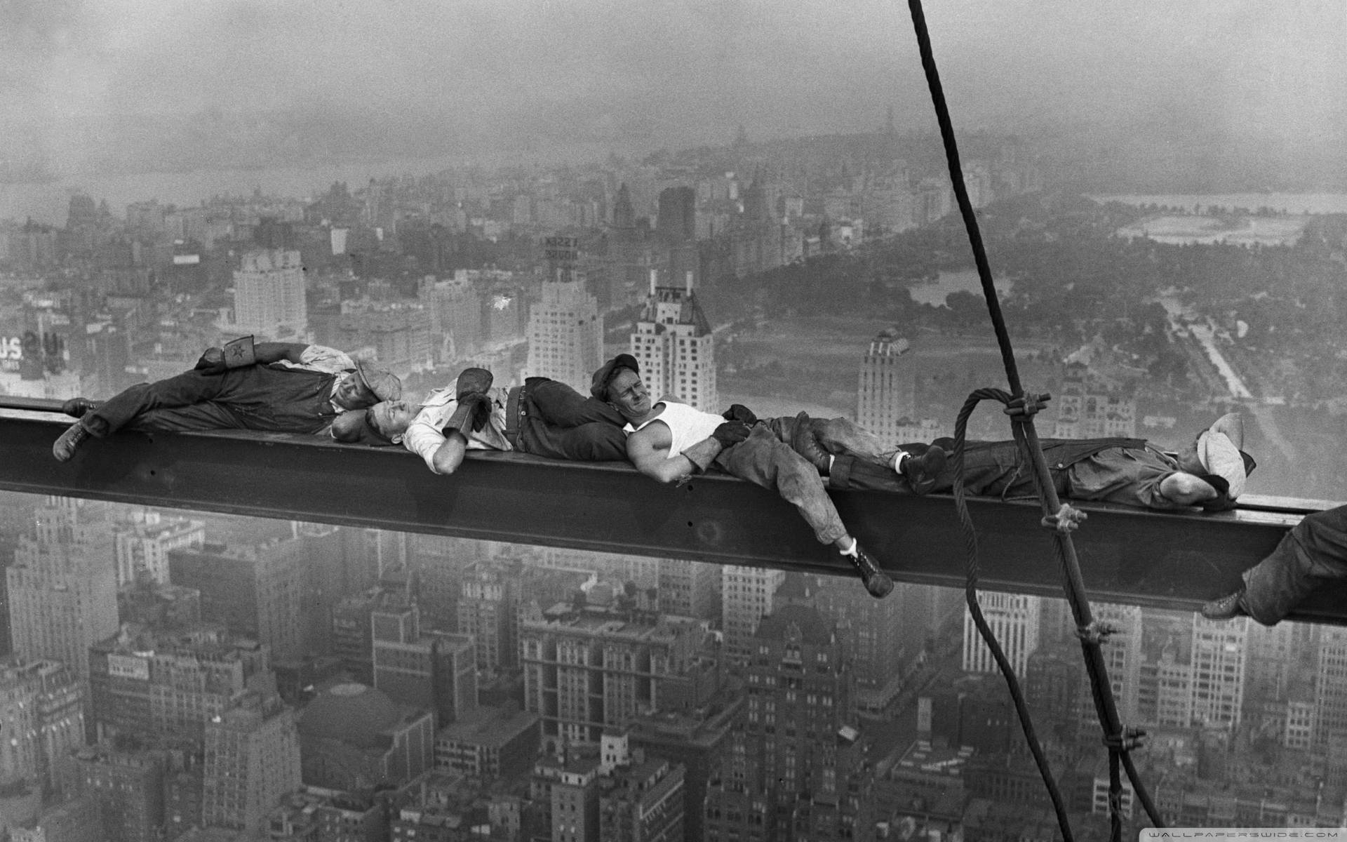Construction Workers Resting Over The Crane Extension Background
